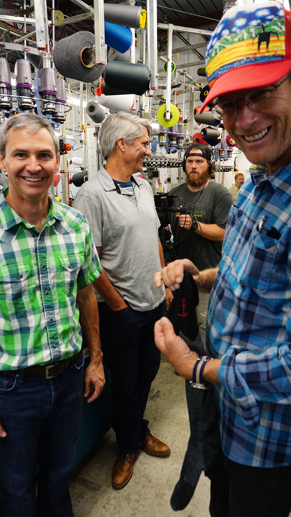 Smartwool Director of Sock Development, John Ramsey, left, and Pro Explorer Conrad Anker, right, tour the brand’s sock-making factory.