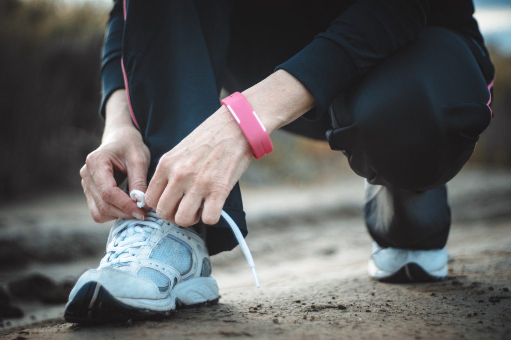 female jogger tying shoe laces