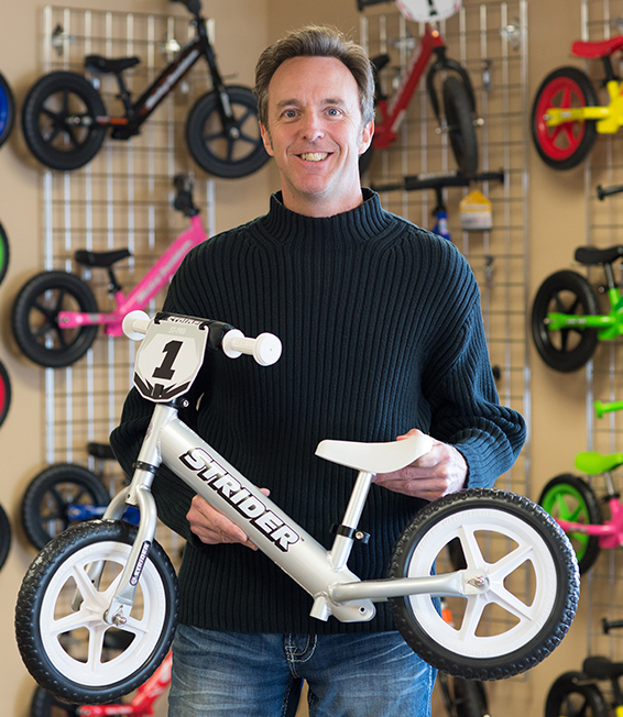 kid riding strider bike