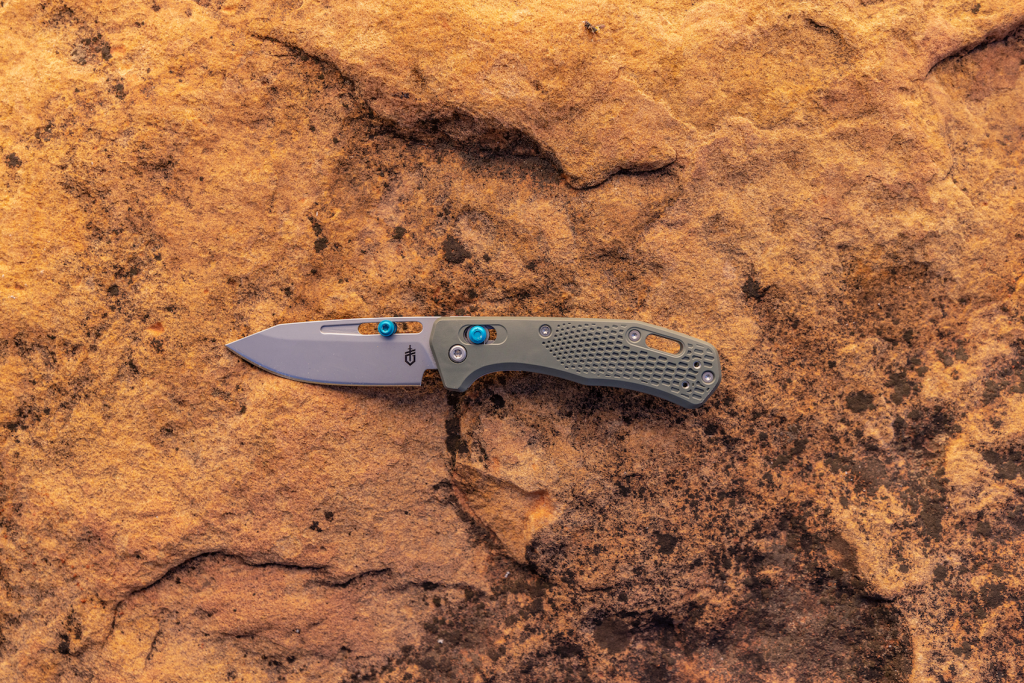 One pocket knife displayed on rock.